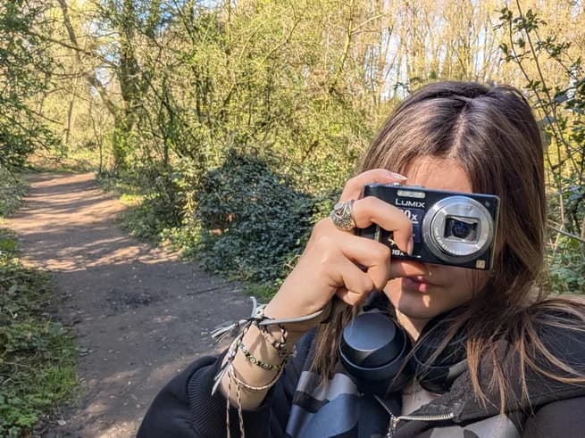 Carolina taking a photo outdoors